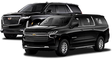 A black Chevrolet Suburban and a black Cadillac Escalade.